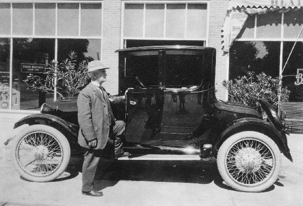 William standing by car